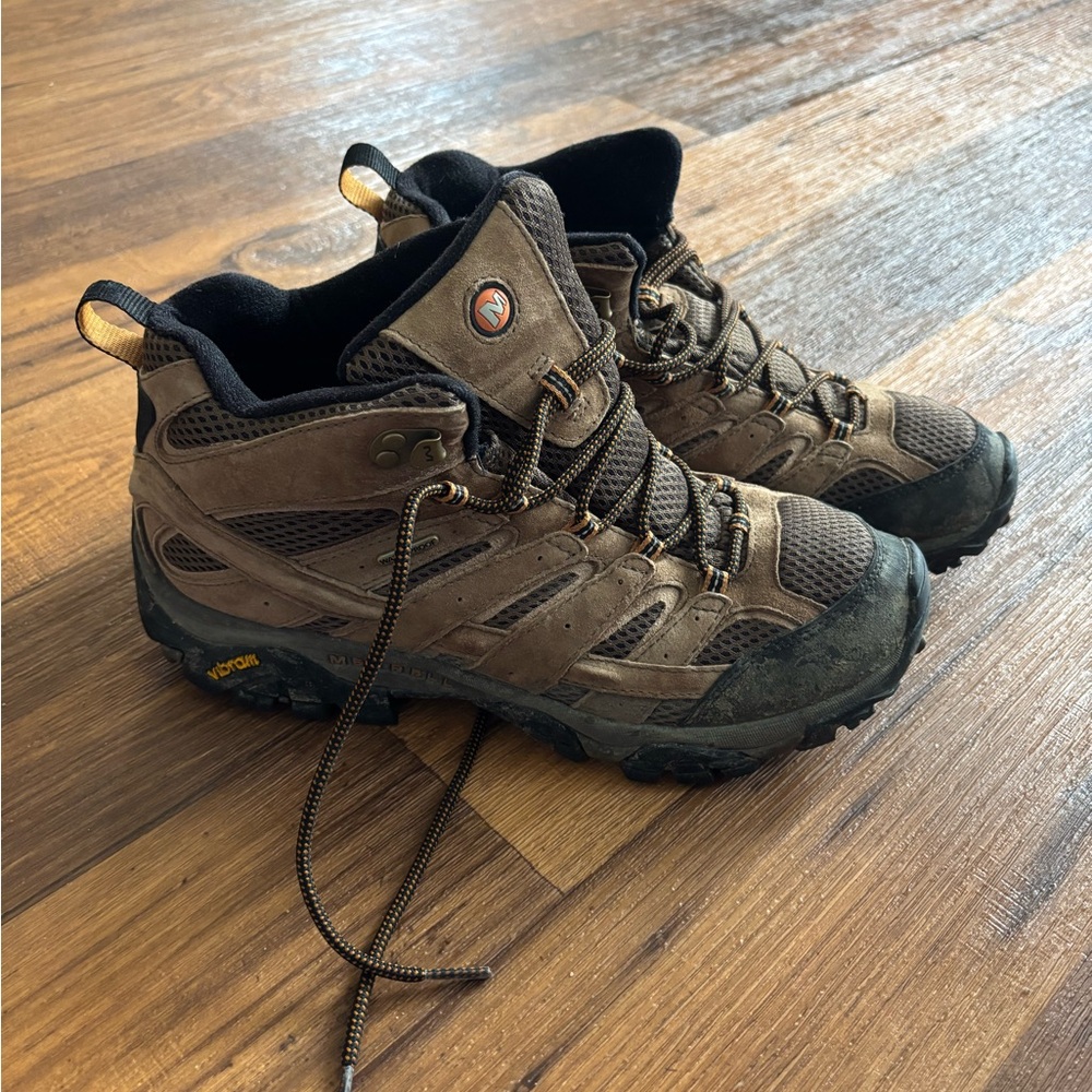 Brown rugged outdoor boots with high-top design and durable materials